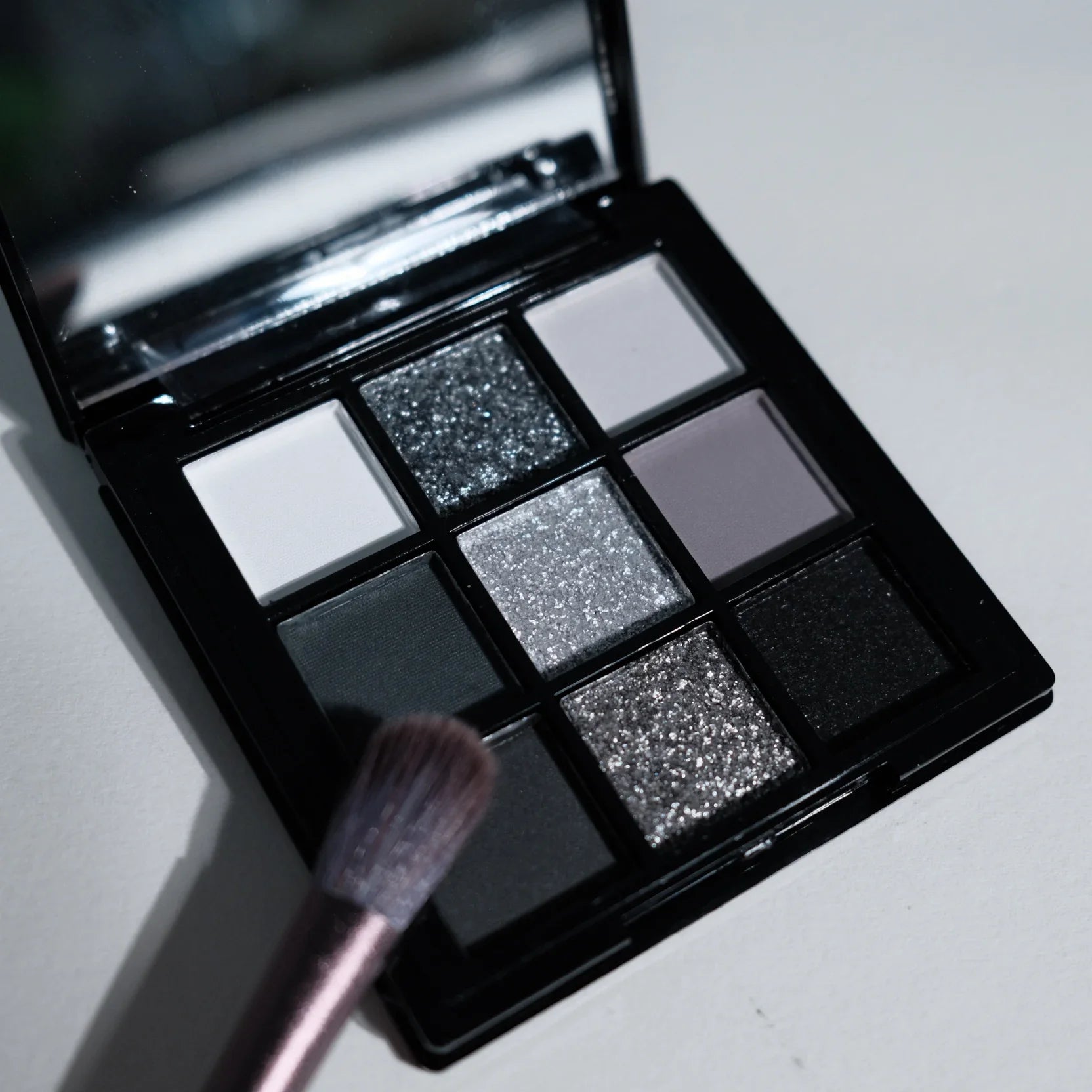 9-shade eyeshadow palette: Black Swan, Smoky, Dark Black, Grey Silver Glitter, Matte Finish, Long-lasting, and easy to color